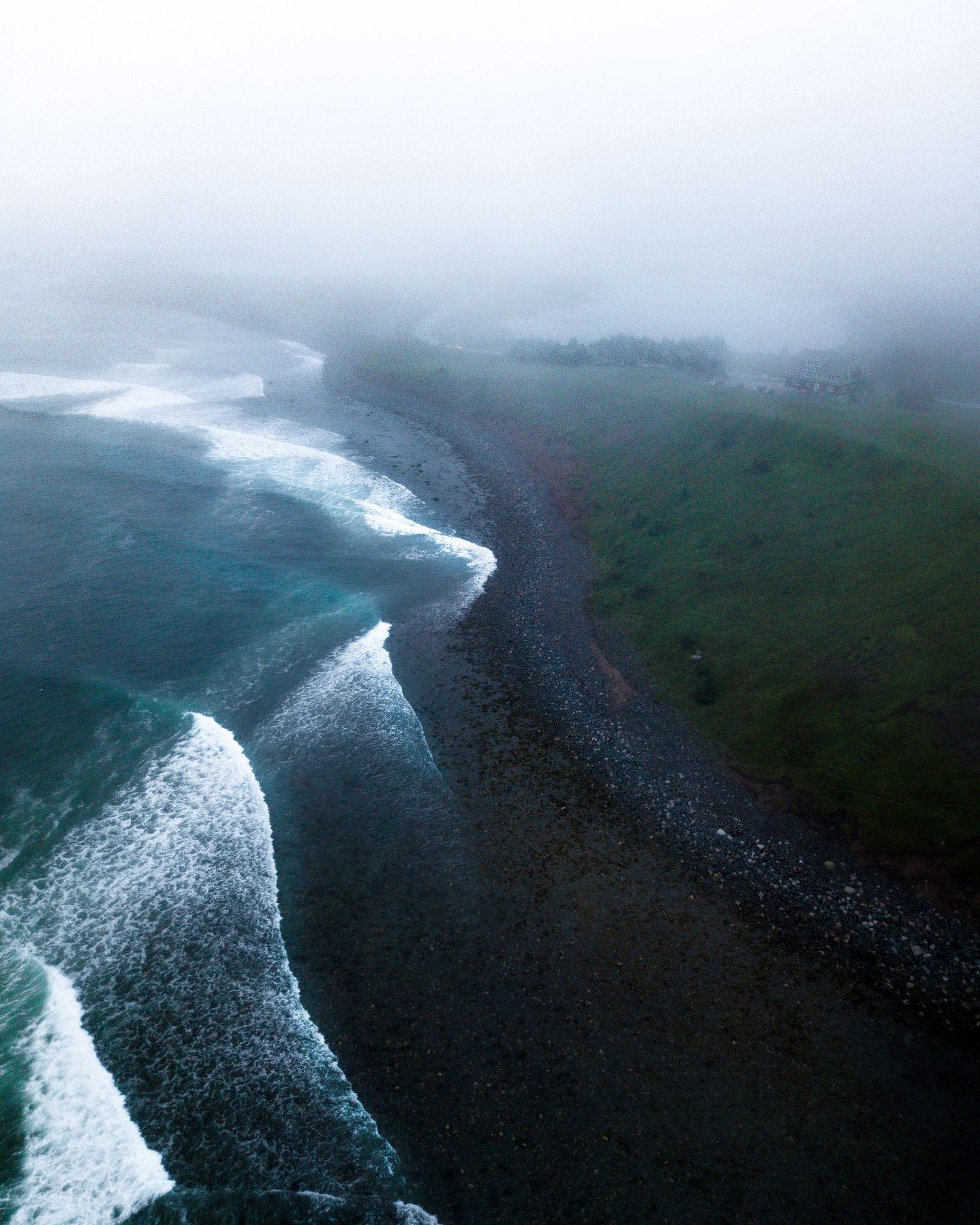 Mist rolling over a dramatic ocean coastline